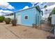 Blue storage building or outbuilding exterior with white door and fenced-in yard, ideal for extra space at 201 S Greenfield Rd # 144, Mesa, AZ 85206