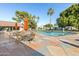Beautiful community pool area with tables, chairs, and well-maintained landscaping at 201 S Greenfield Rd # 144, Mesa, AZ 85206
