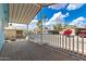Spacious covered porch with wood flooring offering a view of the neighborhood and blue skies at 201 S Greenfield Rd # 144, Mesa, AZ 85206