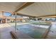 Community shuffleboard court under a covered structure, great for year-round entertainment at 201 S Greenfield Rd # 144, Mesa, AZ 85206