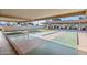 Relaxing shuffleboard court with red flags offers a fun recreational activity for residents and guests at 201 S Greenfield Rd # 144, Mesa, AZ 85206