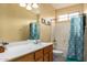 Standard bathroom with a wood cabinet, large mirror, and shower-tub combo at 2055 W Jasper Butte Dr, Queen Creek, AZ 85144