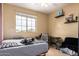 Bright bedroom with a ceiling fan, large window, desk, shelving, and comfy accents at 2055 W Jasper Butte Dr, Queen Creek, AZ 85144