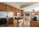Efficient kitchen features stainless steel appliances, oak cabinets, and an eat-in dining area at 2055 W Jasper Butte Dr, Queen Creek, AZ 85144