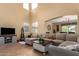 Bright living room features high ceilings, neutral tones, and a large comfortable sectional sofa at 2055 W Jasper Butte Dr, Queen Creek, AZ 85144