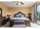 Inviting main bedroom includes a king-size bed, dresser, and a sliding glass door leading to a balcony at 2055 W Jasper Butte Dr, Queen Creek, AZ 85144