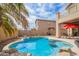 Sparkling pool with rock accents, surrounded by desert landscaping in a private backyard at 2055 W Jasper Butte Dr, Queen Creek, AZ 85144