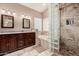 This bathroom offers a dual sink vanity with granite counters, tile backsplash, a tub, and a walk-in shower at 2131 E New Bedford Dr, Gilbert, AZ 85234