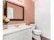 This bathroom offers a single sink vanity with a stone countertop, decorative lighting, and a toilet at 2131 E New Bedford Dr, Gilbert, AZ 85234