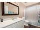 This bathroom offers a single sink vanity, a framed mirror, decorative lighting, and a shower with a curtain at 2131 E New Bedford Dr, Gilbert, AZ 85234