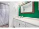 Bright bathroom with white vanity, decorative mirror, sink, and walk-in shower at 2131 E New Bedford Dr, Gilbert, AZ 85234