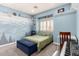 This bedroom features a mural, a carpeted floor, a shuttered window, built-in shelves and ample room to relax at 2131 E New Bedford Dr, Gilbert, AZ 85234
