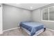 Cozy bedroom featuring neutral walls, carpet flooring, and a comfortable bed by the window at 2131 E New Bedford Dr, Gilbert, AZ 85234