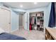 Bright bedroom with a large closet, carpet flooring, light blue walls, and white trim at 2131 E New Bedford Dr, Gilbert, AZ 85234