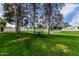 Lush green community park with picnic table surrounded by trees and landscaping at 2131 E New Bedford Dr, Gilbert, AZ 85234