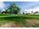 Beautiful community park featuring walking paths, lush green grass, playground, and mature landscaping at 2131 E New Bedford Dr, Gilbert, AZ 85234