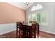 Dining room featuring a table with seating for six, hardwood floors, and natural light at 2131 E New Bedford Dr, Gilbert, AZ 85234