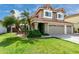 Attractive house with a terracotta tile roof, green lawn, and beautiful landscaping at 2131 E New Bedford Dr, Gilbert, AZ 85234