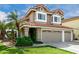Home exterior boasting a three-car garage, well-maintained landscaping, and a classic red-tile roof at 2131 E New Bedford Dr, Gilbert, AZ 85234