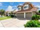 Two story house with three car garage, neutral color scheme, and a terracotta roof at 2131 E New Bedford Dr, Gilbert, AZ 85234