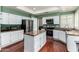 Well-lit kitchen with stainless steel appliances, island, and green walls at 2131 E New Bedford Dr, Gilbert, AZ 85234
