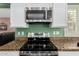Modern kitchen featuring stainless steel stove, microwave, and granite counters at 2131 E New Bedford Dr, Gilbert, AZ 85234