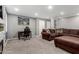 Finished basement features a comfortable sectional sofa, desk, and gray walls at 2131 E New Bedford Dr, Gilbert, AZ 85234