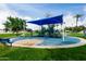 Shaded community playground with cushioned ground, seating, and surrounding landscaping at 2131 E New Bedford Dr, Gilbert, AZ 85234
