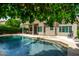 Lush landscaping surrounds the refreshing pool, creating a private backyard oasis at 2131 E New Bedford Dr, Gilbert, AZ 85234