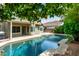 Enjoy relaxing days by the pool in this backyard, shaded by a lemon tree at 2131 E New Bedford Dr, Gilbert, AZ 85234