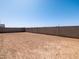 Expansive backyard, surrounded by block fencing, ready for landscaping at 24493 W Grenadine Rd, Buckeye, AZ 85326