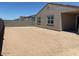 Spacious backyard featuring a covered patio, offering ample space for outdoor activities and relaxation at 24493 W Grenadine Rd, Buckeye, AZ 85326