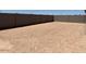 Large backyard enclosed by a tall block wall, providing privacy and security, great for recreation at 24493 W Grenadine Rd, Buckeye, AZ 85326