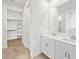 Bright bathroom featuring double sink vanity and walk-in closet at 24493 W Grenadine Rd, Buckeye, AZ 85326