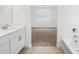 Bathroom with soaking tub, vanity and carpeted room in the background at 24493 W Grenadine Rd, Buckeye, AZ 85326