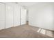 Bright bedroom featuring neutral-toned plush carpet, a view into the hallway, and a closet at 24493 W Grenadine Rd, Buckeye, AZ 85326