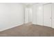 Bright bedroom featuring neutral-toned plush carpet, a view into the hallway, and a closet at 24493 W Grenadine Rd, Buckeye, AZ 85326