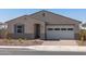 A charming single-story home with a two-car garage, neutral stucco exterior, and low-maintenance desert landscaping at 24493 W Grenadine Rd, Buckeye, AZ 85326
