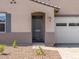 Close-up of the home's front door with a charming walkway and desert landscaping, offering curb appeal at 24493 W Grenadine Rd, Buckeye, AZ 85326