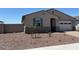 Attractive single-story home features desert landscaping, inviting entryway, and a convenient two-car garage at 24493 W Grenadine Rd, Buckeye, AZ 85326