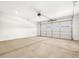 Spacious two-car garage with neutral walls, overhead lighting, and automatic door at 24493 W Grenadine Rd, Buckeye, AZ 85326
