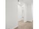 Neutral-toned hallway with ceramic tile and bright lighting offering a view of the home's layout and design at 24493 W Grenadine Rd, Buckeye, AZ 85326