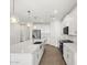 A modern kitchen featuring white cabinets, stainless steel appliances, and a large island at 24493 W Grenadine Rd, Buckeye, AZ 85326