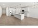 A bright, open-concept kitchen featuring a large center island, stainless steel appliances and white cabinetry at 24493 W Grenadine Rd, Buckeye, AZ 85326