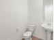 Cozy powder room features sleek pedestal sink and toilet at 24493 W Grenadine Rd, Buckeye, AZ 85326