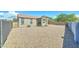 Expansive backyard features neutral stone landscaping and block wall fencing for privacy at 25755 W Hazel Dr, Buckeye, AZ 85326