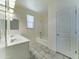 Bright bathroom features a dual sink vanity, tiled flooring, and a shower-tub combo at 25755 W Hazel Dr, Buckeye, AZ 85326