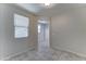 A cozy bedroom featuring tiled flooring and view to the home's interior at 25755 W Hazel Dr, Buckeye, AZ 85326