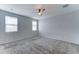 Carpeted bedroom with a ceiling fan and multiple windows offering plenty of natural light at 25755 W Hazel Dr, Buckeye, AZ 85326