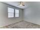 A bedroom features carpeted flooring, neutral paint, and natural lighting at 25755 W Hazel Dr, Buckeye, AZ 85326